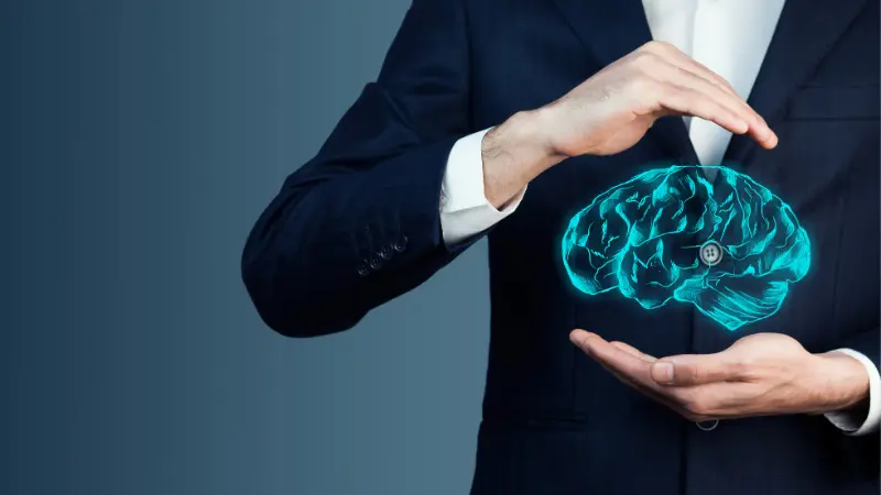 Homme d'affaire, cerveau positionné entre ses main