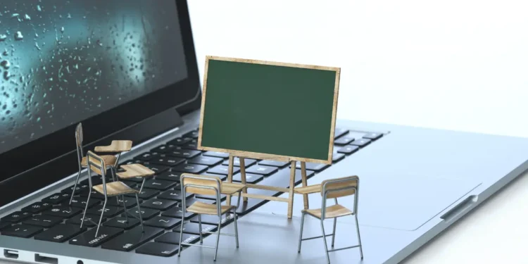 Tableau noir et chaises sur le clavier d'un ordinateur portable, rendu 3D, image conceptuelle. Concepts de formation en ligne et d'apprentissage en ligne